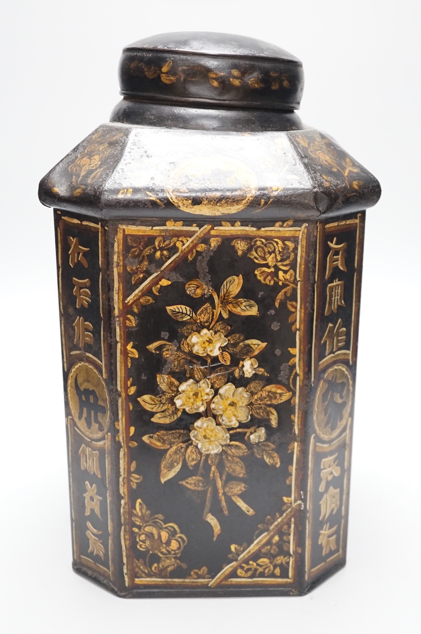 A 19th century toleware octagonal tea canister, J. Newman, Dublin, painted with flowers and Chinese script, 36cm